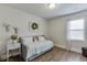 Cozy bedroom features natural light, wood-look flooring, and neutral decor at 4650 Silver Meadow Dr, Buford, GA 30519