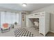 Playful bedroom with lofted bed over a desk and checkerboard rug at 4650 Silver Meadow Dr, Buford, GA 30519