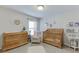 Charming Bedroom featuring a wooden crib, changing table, decor, and natural light at 4650 Silver Meadow Dr, Buford, GA 30519