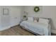 Comfortable bedroom with a daybed, wood-look flooring, and double door closet at 4650 Silver Meadow Dr, Buford, GA 30519