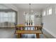 Dining area features a modern light fixture, table with chairs, and large windows at 4650 Silver Meadow Dr, Buford, GA 30519