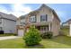 Beautiful two-story home with a well-kept lawn, stone details, and a convenient two-car garage at 4650 Silver Meadow Dr, Buford, GA 30519