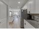 Modern kitchen with white cabinets, stainless steel appliances, granite counters and open layout at 4650 Silver Meadow Dr, Buford, GA 30519