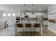 Bright, open kitchen with granite countertops, stainless steel appliances, and bar stool seating at the island at 4650 Silver Meadow Dr, Buford, GA 30519