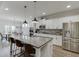 Spacious kitchen featuring a large island with seating, stainless steel appliances, and adjacent dining area at 4650 Silver Meadow Dr, Buford, GA 30519