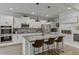 Bright kitchen with white cabinets, granite counters, stainless steel appliances, and bar stool seating at 4650 Silver Meadow Dr, Buford, GA 30519