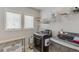 Functional laundry room with modern washer and dryer, shelving, and natural light from two windows at 4650 Silver Meadow Dr, Buford, GA 30519