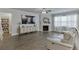 Open living room with a fireplace and views to the connected rooms at 4650 Silver Meadow Dr, Buford, GA 30519