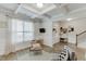 Well-lit living room with hardwood floors, comfortable seating, and neutral décor, with stairway visible at 4650 Silver Meadow Dr, Buford, GA 30519