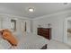This spacious main bedroom features a comfortable bed with soft decorative pillows and lighting at 4650 Silver Meadow Dr, Buford, GA 30519