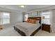 This spacious main bedroom features a comfortable bed with soft decorative pillows and lighting at 4650 Silver Meadow Dr, Buford, GA 30519