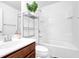 Bright bathroom featuring a tub and shower combination, and a modern sink with shelving at 1929 Brightleaf Way, Marietta, GA 30060