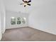 Expansive primary bedroom with neutral carpet, a ceiling fan, and large windows at 1929 Brightleaf Way, Marietta, GA 30060