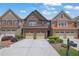 Charming brick townhome with a two-car garage, manicured landscaping, and inviting curb appeal at 1929 Brightleaf Way, Marietta, GA 30060