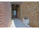 Brick entryway of townhome with a solid front door, plants, and a small walkway at 1929 Brightleaf Way, Marietta, GA 30060