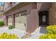 Close up of a lovely brick townhome showcasing a two-car garage and covered front entryway at 1929 Brightleaf Way, Marietta, GA 30060