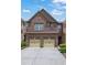 Charming two-story brick townhome with a two-car garage and well-maintained landscaping at 1929 Brightleaf Way, Marietta, GA 30060