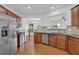 Modern kitchen featuring stainless steel appliances, granite countertops, wood cabinets, and hardwood floors at 1929 Brightleaf Way, Marietta, GA 30060