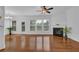 Bright living room featuring a fireplace, ceiling fan, hardwood floors, and ample natural light at 1929 Brightleaf Way, Marietta, GA 30060