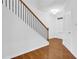 Stairway with wood banister and iron spindles leads to upper level at 1929 Brightleaf Way, Marietta, GA 30060