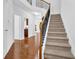 Inviting stairway featuring carpeted steps, wood railings, and hardwood floors in the entryway at 1929 Brightleaf Way, Marietta, GA 30060