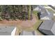 Aerial view of gray-roofed homes and landscaped backyards. Features include some trees and small bushes between the properties at 22 Foothills Trl, Sharpsburg, GA 30277