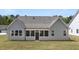 Gray home with screen porch and a well-maintained backyard with green lawn, creating an inviting outdoor space at 22 Foothills Trl, Sharpsburg, GA 30277