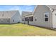 Well-maintained backyard with green lawn, screen porch, and the rear of a gray home, creating an inviting outdoor space at 22 Foothills Trl, Sharpsburg, GA 30277