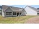 Gray home with screen porch and a well-maintained backyard with green lawn, creating an inviting outdoor space at 22 Foothills Trl, Sharpsburg, GA 30277