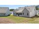 Well-maintained backyard with green lawn, screen porch, and the rear of a gray home, creating an inviting outdoor space at 22 Foothills Trl, Sharpsburg, GA 30277