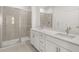 Modern bathroom with dual sinks, quartz countertops, and tiled shower with glass door at 22 Foothills Trl, Sharpsburg, GA 30277