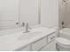 Well-lit bathroom featuring quartz countertops, single sink, and a tiled shower/tub combo at 22 Foothills Trl, Sharpsburg, GA 30277