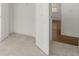 Bedroom features neutral carpet, white walls, and a glimpse of a wood-floored room at 22 Foothills Trl, Sharpsburg, GA 30277