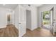 Inviting entryway with wood-look floors, white walls and trim, and an open front door at 22 Foothills Trl, Sharpsburg, GA 30277