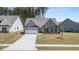 Charming single-story home with a gray exterior, well-manicured lawn, and a spacious two-car garage at 22 Foothills Trl, Sharpsburg, GA 30277