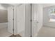 Hallway features tile flooring, with view of bathroom and carpeted bedroom at 22 Foothills Trl, Sharpsburg, GA 30277