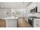 Bright kitchen featuring stainless steel appliances, white cabinets, a subway tile backsplash, and a central island at 22 Foothills Trl, Sharpsburg, GA 30277