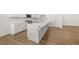 Beautiful kitchen with an island, quartz countertop, stainless steel appliances, and hardwood floors at 22 Foothills Trl, Sharpsburg, GA 30277