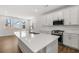 Well-lit kitchen with a center island, stainless steel appliances, white cabinets and ample counter space at 22 Foothills Trl, Sharpsburg, GA 30277