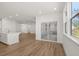 Open-concept living space with wood-look floors, recessed lighting, and sliding door at 22 Foothills Trl, Sharpsburg, GA 30277