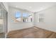 Bright living room features wood-look flooring, multiple windows, and neutral paint at 22 Foothills Trl, Sharpsburg, GA 30277