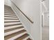 Elegant staircase featuring wood treads, white risers, and a wooden handrail, showcasing a blend of classic and modern design at 22 Foothills Trl, Sharpsburg, GA 30277