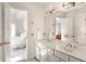 Bright bathroom featuring double vanity, white cabinets and view into light-filled main bedroom at 320 Kirk Rd, Decatur, GA 30030