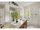 Bright bathroom featuring a wood vanity with a white countertop, large mirror, and natural light at 320 Kirk Rd, Decatur, GA 30030