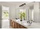 Bathroom featuring a double sink vanity, large mirror, and access to another room with natural light at 320 Kirk Rd, Decatur, GA 30030