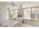 Bright bathroom with a double sink vanity, granite countertops and tub at 320 Kirk Rd, Decatur, GA 30030