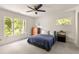 Bedroom featuring a ceiling fan and large windows overlooking lush greenery at 320 Kirk Rd, Decatur, GA 30030