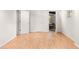 A bright bedroom featuring wood laminate flooring, white walls, and multiple doors at 320 Kirk Rd, Decatur, GA 30030