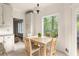 Bright breakfast nook features natural light, a wooden table, and views of the surrounding trees at 320 Kirk Rd, Decatur, GA 30030