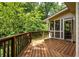 Spacious wood deck surrounded by lush greenery, perfect for outdoor relaxation at 320 Kirk Rd, Decatur, GA 30030
